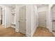 Hallway with hardwood floors, storage, and access to other areas of the home at 3772 Tielman St, Snellville, GA 30078