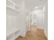 Hallway with wood floors, coat storage, and a view into a light-filled room at 3772 Tielman St, Snellville, GA 30078