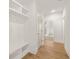Bright hallway with hardwood floors, built-in shelving, and white trim at 3772 Tielman St, Snellville, GA 30078
