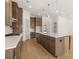 Stylish kitchen showcasing a center island with seating, modern pendant lighting, and generous counter space at 3772 Tielman St, Snellville, GA 30078
