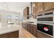 Open-concept kitchen with stainless steel appliances, ample counter space, and contemporary design at 3772 Tielman St, Snellville, GA 30078