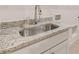 Functional laundry area with granite countertop, stainless steel sink, and custom cabinetry at 3772 Tielman St, Snellville, GA 30078