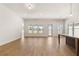 Open living room filled with natural light, hardwood flooring, and seamless access to the outdoor view at 3772 Tielman St, Snellville, GA 30078