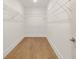 Walk-in closet offering efficient storage solutions with wire shelving and hardwood floors at 3772 Tielman St, Snellville, GA 30078