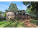 Backyard featuring a screened porch, deck, and lush greenery for outdoor living and entertaining at 3824 N Cooper Lake Se Rd, Smyrna, GA 30082