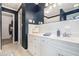 Bright bathroom boasting white cabinets and classic design elements at 3824 N Cooper Lake Se Rd, Smyrna, GA 30082