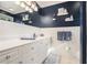 Well-lit bathroom with white tile walls, white cabinetry, and a blue accent wall at 3824 N Cooper Lake Se Rd, Smyrna, GA 30082