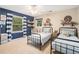 Inviting bedroom showcasing twin beds, ample natural light, and playful decor at 3824 N Cooper Lake Se Rd, Smyrna, GA 30082