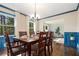 Elegant dining room with hardwood floors, a wooden table, and bright windows, perfect for Gathering meals and gatherings at 3824 N Cooper Lake Se Rd, Smyrna, GA 30082