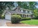 View of the brick home's exterior with a garage, showcasing its architectural style and well-maintained landscaping at 3824 N Cooper Lake Se Rd, Smyrna, GA 30082