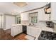 Bright kitchen featuring white cabinetry, stone countertops, and stainless steel appliances, offering a functional cooking space at 3824 N Cooper Lake Se Rd, Smyrna, GA 30082