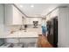 Modern kitchen with white cabinets, marble countertops, stainless steel appliances, and hardwood floors providing a sleek design at 3824 N Cooper Lake Se Rd, Smyrna, GA 30082