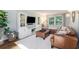 Cozy living room showcasing a leather sectional, built-in shelving, and ample natural light for a welcoming atmosphere at 3824 N Cooper Lake Se Rd, Smyrna, GA 30082