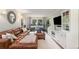 Bright living room with a leather sofa, entertainment center, and large windows, perfect for relaxation and entertainment at 3824 N Cooper Lake Se Rd, Smyrna, GA 30082