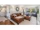 Inviting living room featuring a leather sofa, hardwood floors, and stylish decor, creating a comfortable living space at 3824 N Cooper Lake Se Rd, Smyrna, GA 30082