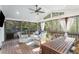 Relaxing screened porch with outdoor seating, a ceiling fan, and views of the surrounding greenery, offering a serene retreat at 3824 N Cooper Lake Se Rd, Smyrna, GA 30082