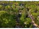 Aerial view showcases a secluded home nestled among lush green trees and mature landscaping at 6990 Brandon Mill Nw Rd, Atlanta, GA 30328