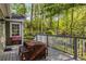 Outdoor deck with a dining table and view of a wooded backyard at 6990 Brandon Mill Nw Rd, Atlanta, GA 30328