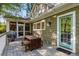 Outdoor oasis with a wooden deck, dining table, grill, and access to a screened-in porch, perfect for entertaining at 6990 Brandon Mill Nw Rd, Atlanta, GA 30328