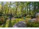 View of a backyard with trees, a playset, and outdoor seating at 6990 Brandon Mill Nw Rd, Atlanta, GA 30328