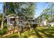 Charming home with a spacious backyard, screened porch, swing set, and lush landscaping at 6990 Brandon Mill Nw Rd, Atlanta, GA 30328