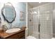 Charming bathroom with a wood vanity, stylish mirror, and glass-enclosed shower, creating a delightful space at 6990 Brandon Mill Nw Rd, Atlanta, GA 30328