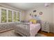 A cozy bedroom with a patterned rug and large window for natural light at 6990 Brandon Mill Nw Rd, Atlanta, GA 30328