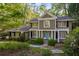Charming two-story home featuring a landscaped front yard and a welcoming blue front door at 6990 Brandon Mill Nw Rd, Atlanta, GA 30328