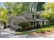 Charming home exterior with a well-manicured lawn and mature trees at 6990 Brandon Mill Nw Rd, Atlanta, GA 30328