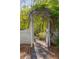 Quaint garden gate with stone path, arched arbor, and lush greenery, creating an inviting entrance at 6990 Brandon Mill Nw Rd, Atlanta, GA 30328