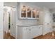 Bright kitchen featuring glass-front cabinets, granite countertops, and hardwood floors at 6990 Brandon Mill Nw Rd, Atlanta, GA 30328