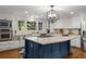 Bright, remodeled kitchen featuring a large island, granite countertops, and white cabinetry at 6990 Brandon Mill Nw Rd, Atlanta, GA 30328