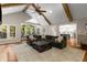 Open living room featuring vaulted ceilings, exposed wood beams, and a large window seat at 6990 Brandon Mill Nw Rd, Atlanta, GA 30328