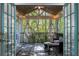 Relaxing screened porch with comfortable seating and views of surrounding trees at 6990 Brandon Mill Nw Rd, Atlanta, GA 30328