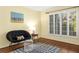 Cozy sitting room featuring hardwood floors, a round papasan chair, and natural light from the bright window at 6990 Brandon Mill Nw Rd, Atlanta, GA 30328