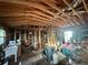 Unfinished Garage with exposed wooden beams, studs, and storage containers at 1471 Holcomb Ave, Atlanta, GA 30344