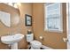 Bathroom featuring a pedestal sink, toilet, and window with natural light at 2281 Millhaven Se St # 18, Smyrna, GA 30080