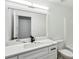 Bright bathroom features a white vanity with a modern sink and black faucet, complemented by a matching toilet and shower at 326 Oakview Way, Canton, GA 30114