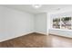 Well-lit bedroom with wood flooring and a window view of neighboring homes at 326 Oakview Way, Canton, GA 30114