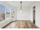 Dining area featuring large windows and light hardwood floors, bathing the room in natural light at 326 Oakview Way, Canton, GA 30114