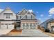 Charming two-story home showcasing a two-car garage and a well-maintained front yard with a beautiful blue sky backdrop at 326 Oakview Way, Canton, GA 30114