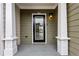 Inviting front porch with white columns and a black door, perfect for a cozy and stylish entrance at 326 Oakview Way, Canton, GA 30114