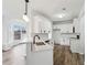Open kitchen featuring quartz countertops, white cabinets, stainless steel appliances, and hardwood floors at 326 Oakview Way, Canton, GA 30114