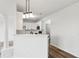 Modern kitchen featuring quartz countertops, white cabinets, hardwood floors, and stainless steel appliances at 326 Oakview Way, Canton, GA 30114