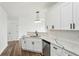 Modern kitchen featuring white cabinets, quartz countertops, stainless steel appliances, and hardwood flooring at 326 Oakview Way, Canton, GA 30114