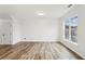 Spacious living room with hardwood floors, white walls, a large window, and neutral tones at 326 Oakview Way, Canton, GA 30114