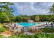 Community pool area with lounge chairs and umbrellas for relaxation and recreation at 326 Oakview Way, Canton, GA 30114