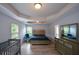 A spacious bedroom features hardwood floors, a tray ceiling, and two windows at 917 Revere Way, Hampton, GA 30228