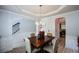 Elegant dining area features crown molding, chair railing, and a view to the staircase at 917 Revere Way, Hampton, GA 30228