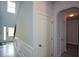 The entryway features hardwood floors, white moulding, and a white door to an adjacent room at 917 Revere Way, Hampton, GA 30228